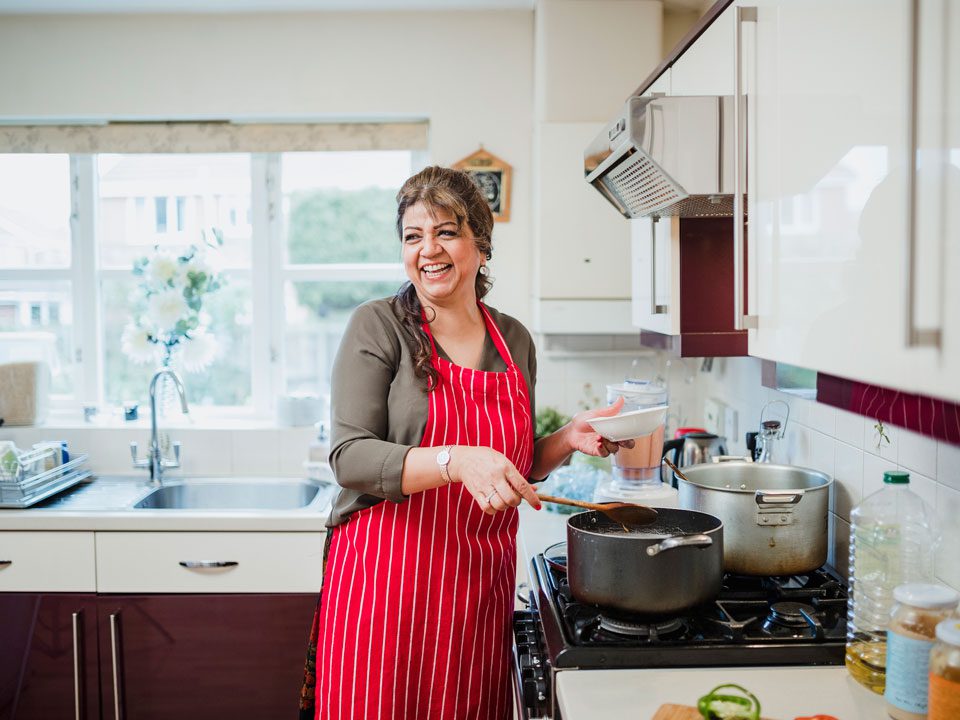 Mature Woman Enjoying Cooking at Home